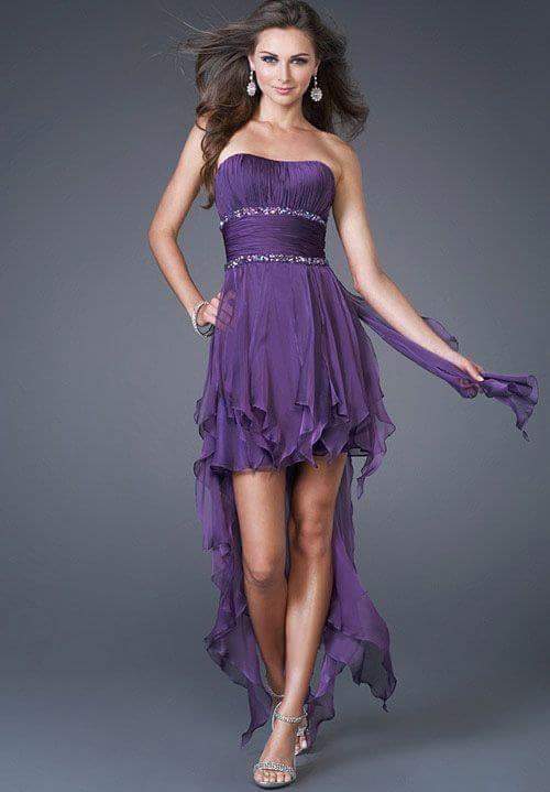 Purple strapless high-low evening dress with crystal embellishments and a long ruffled hem.